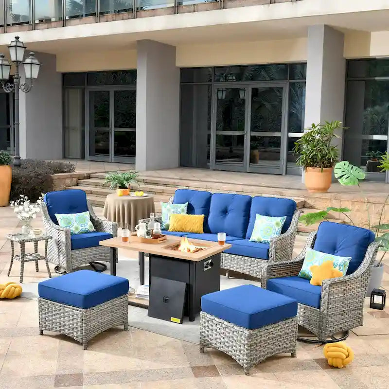 Ensemble de 7 chaises pivotantes incurvées en osier d'extérieur OVIOS avec table de feu